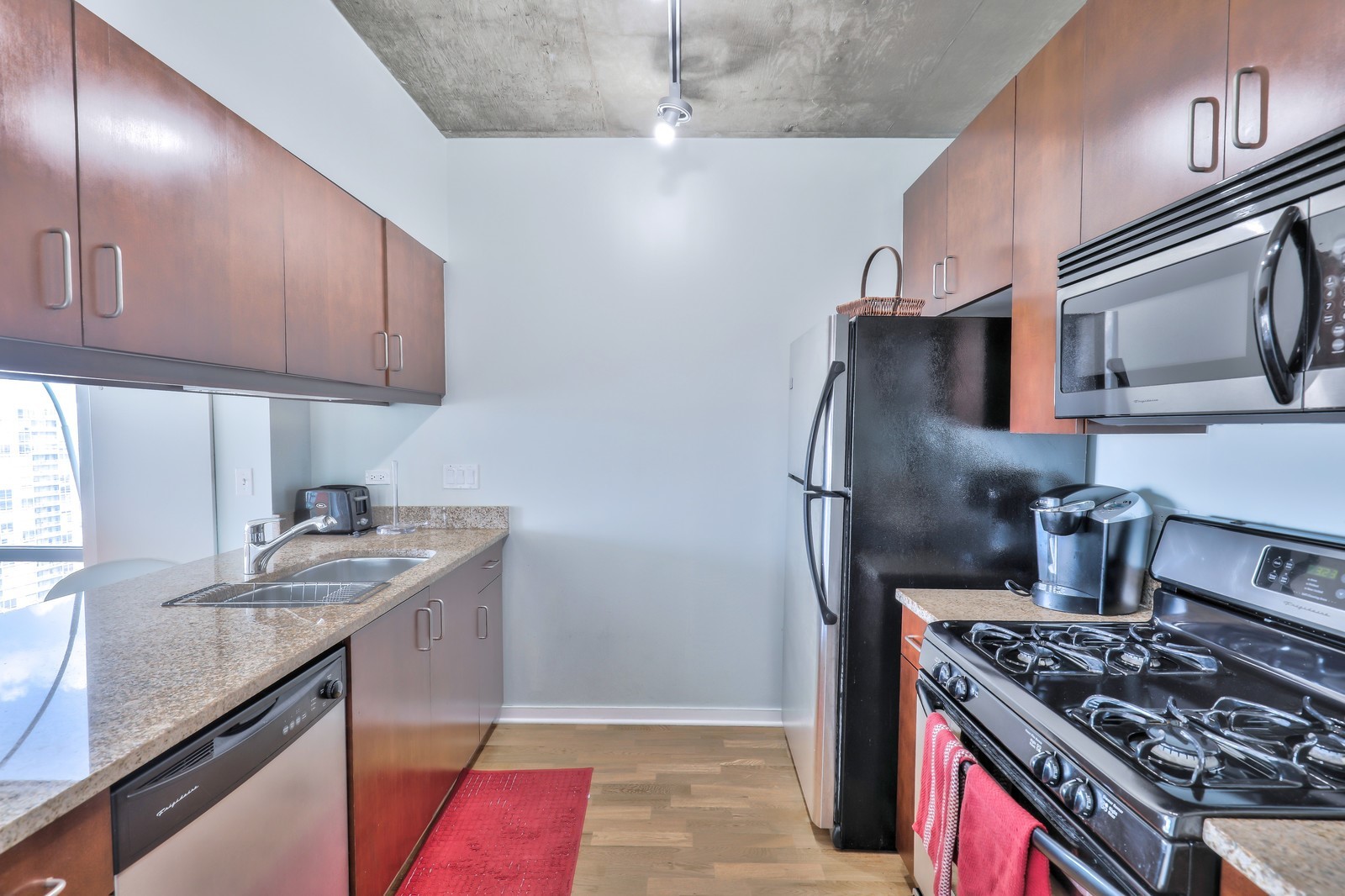 611 South Wells Street, Unit 2808 Chicago, IL 60607 - Photo 7 of 16 a kitchen with stainless steel appliances granite countertop a sink stove and refrigerator