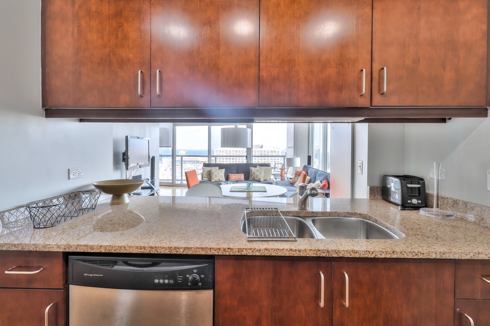 611 South Wells Street, Unit 2808 Chicago, IL 60607 - Photo 8 of 16 a kitchen with granite countertop a sink a stove and cabinets