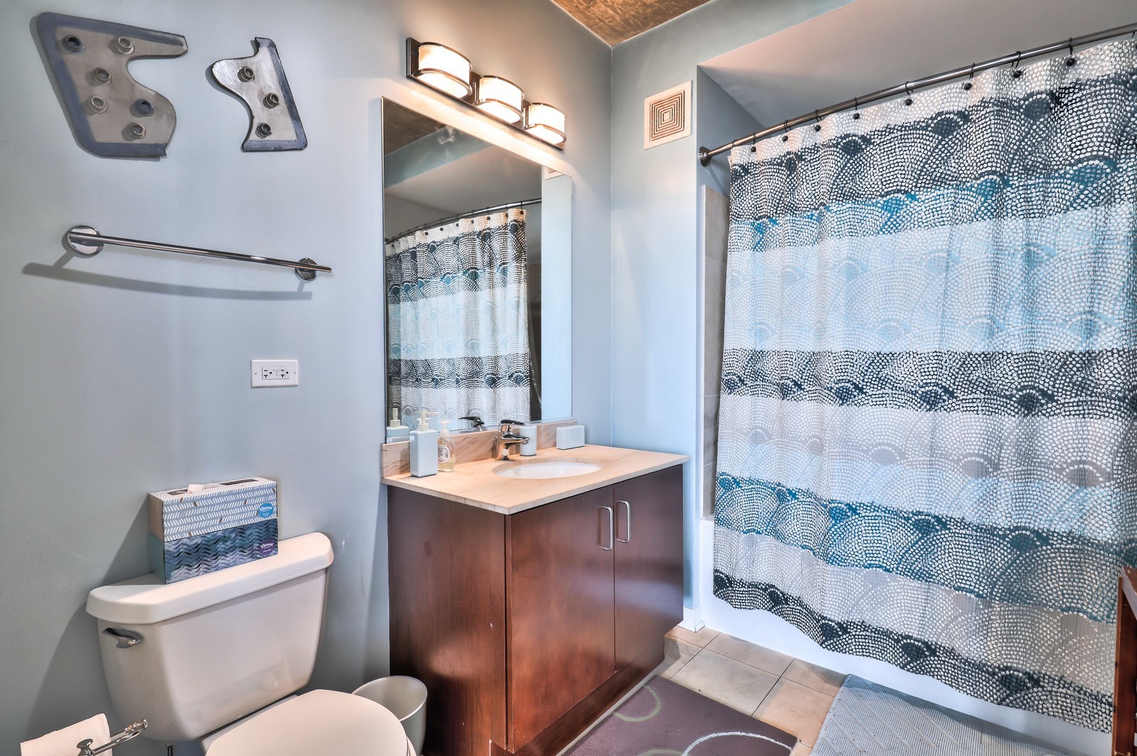 611 South Wells Street, Unit 2808 Chicago, IL 60607 - Photo 10 of 16 a bathroom with a sink mirror vanity and toilet