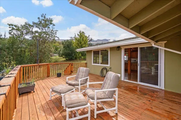 a view of balcony with furniture and wooden deck