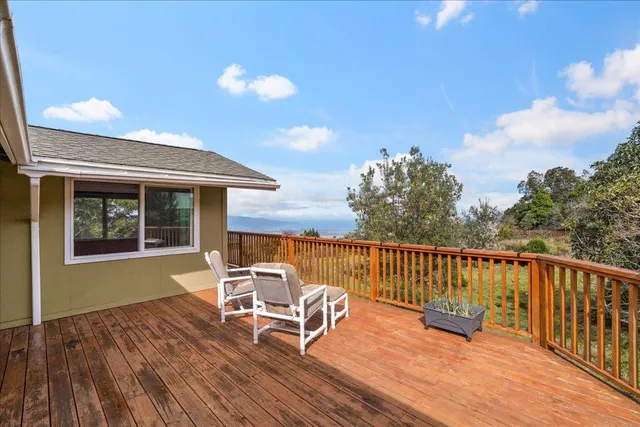 a view of a chair and table on the deck