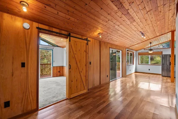 a view of hallway with wooden floor and sliding window