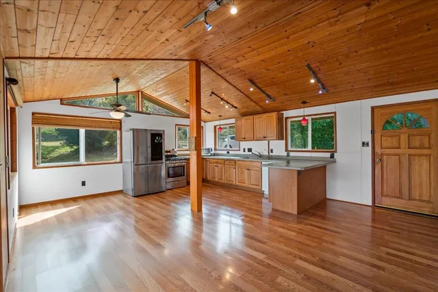a view of kitchen with furniture and wooden floor