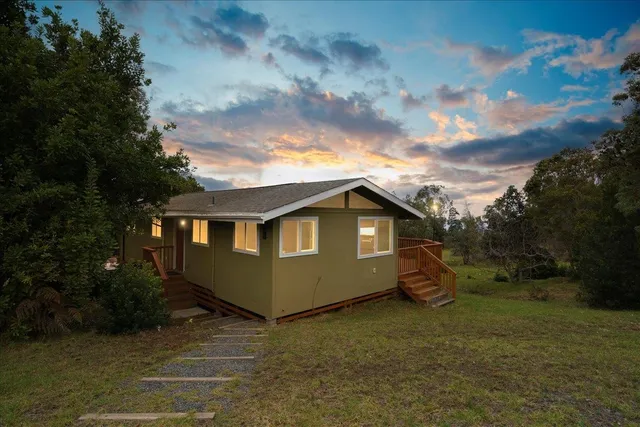 a view of a house with a backyard
