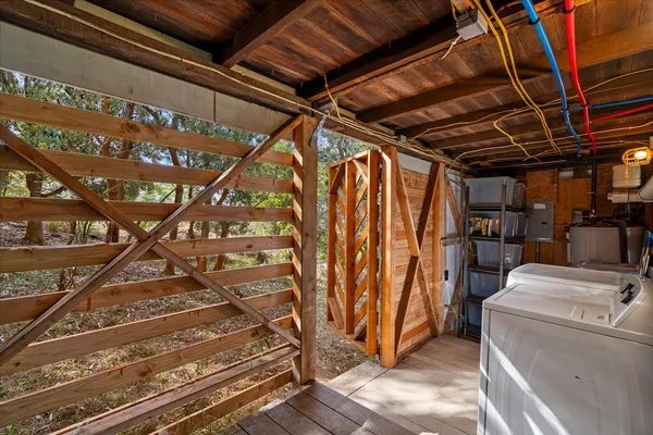 a view of a patio with table and chairs with wooden floor and fence