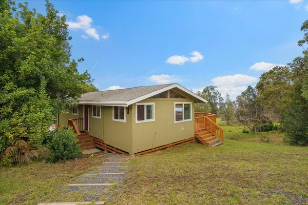 a view of a house with a backyard