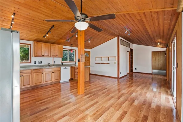 a view of a kitchen with cabinets and wooden floor