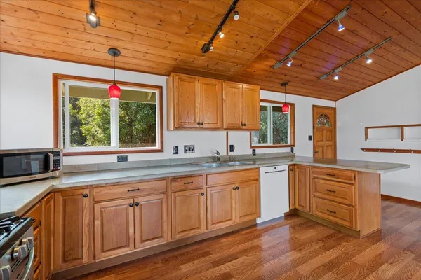 a kitchen with sink cabinets and wooden floor