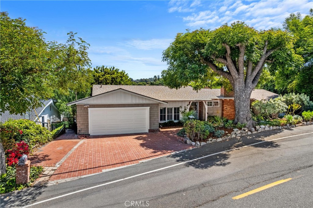 27064 Sunnyridge Road Palos Verdes Peninsula, CA 90274 - Photo 1 of 57 a front view of a house with a garden and trees
