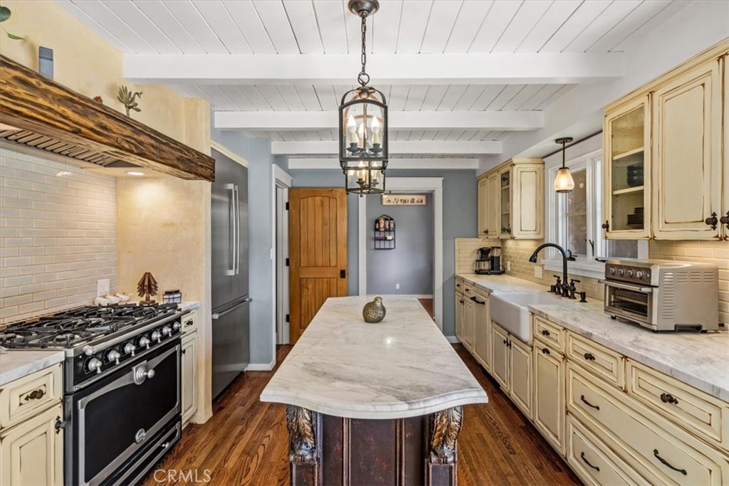 27064 Sunnyridge Road Palos Verdes Peninsula, CA 90274 - Photo 12 of 57 a large kitchen with kitchen island a stove a sink a refrigerator dining table and chairs