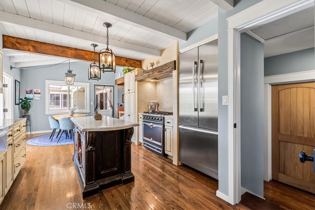 27064 Sunnyridge Road Palos Verdes Peninsula, CA 90274 - Photo 14 of 57 a kitchen with stainless steel appliances kitchen island granite countertop a table chairs and a refrigerator
