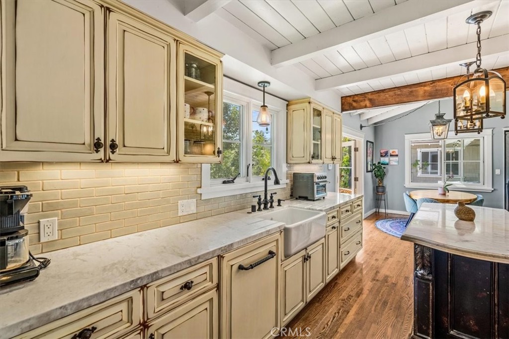 27064 Sunnyridge Road Palos Verdes Peninsula, CA 90274 - Photo 15 of 57 a kitchen with stainless steel appliances granite countertop a sink a stove cabinets and wooden floor
