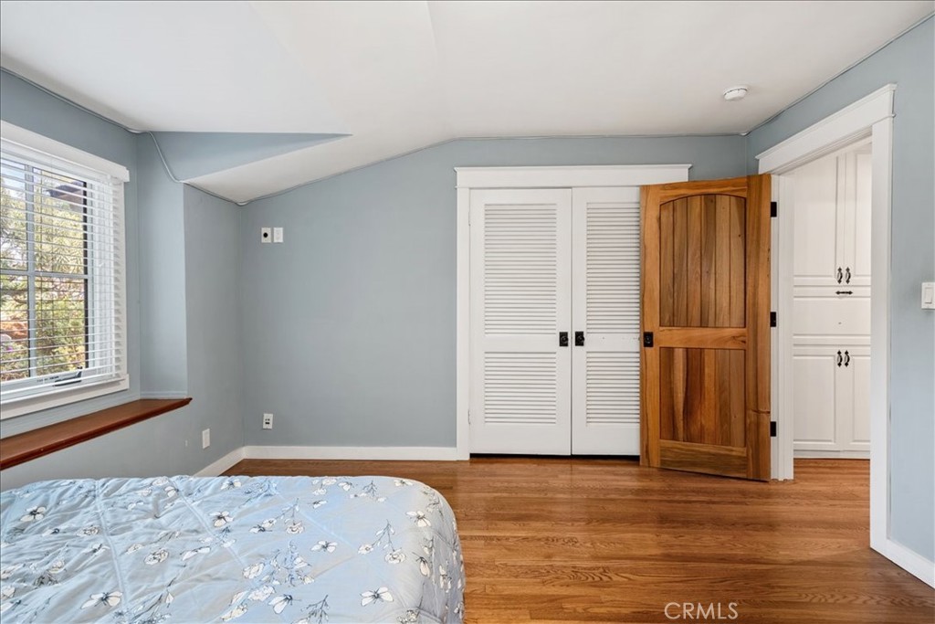 27064 Sunnyridge Road Palos Verdes Peninsula, CA 90274 - Photo 27 of 57 a bedroom with a bed and wooden floor