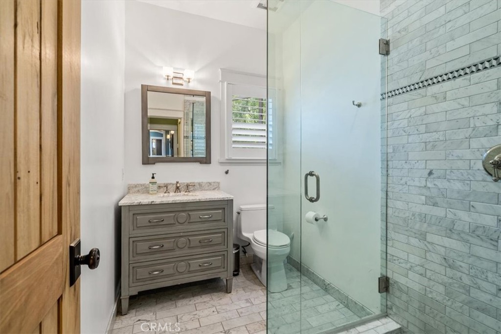 27064 Sunnyridge Road Palos Verdes Peninsula, CA 90274 - Photo 33 of 57 a bathroom with a granite countertop sink a mirror and a shower