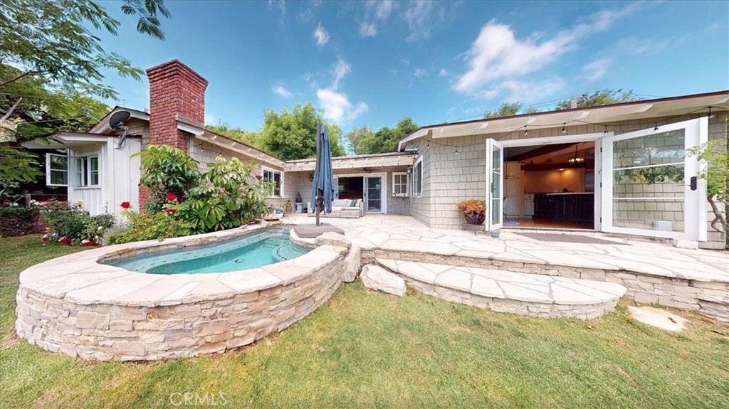27064 Sunnyridge Road Palos Verdes Peninsula, CA 90274 - Photo 35 of 57 a view of a house with swimming pool and a yard