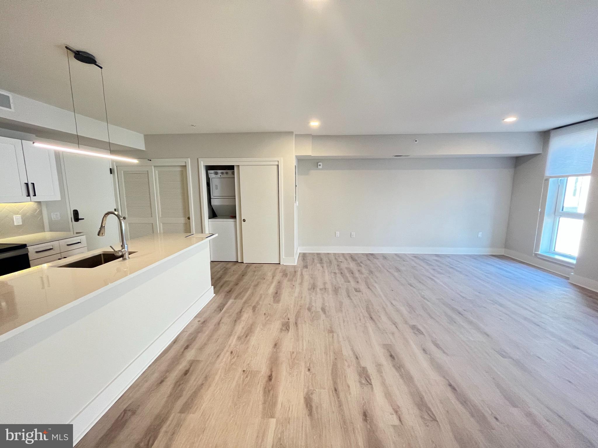 1805 North Howard Street, Unit 303 Philadelphia, PA 19122 - Photo 14 of 25 a view of a kitchen with wooden floor and windows
