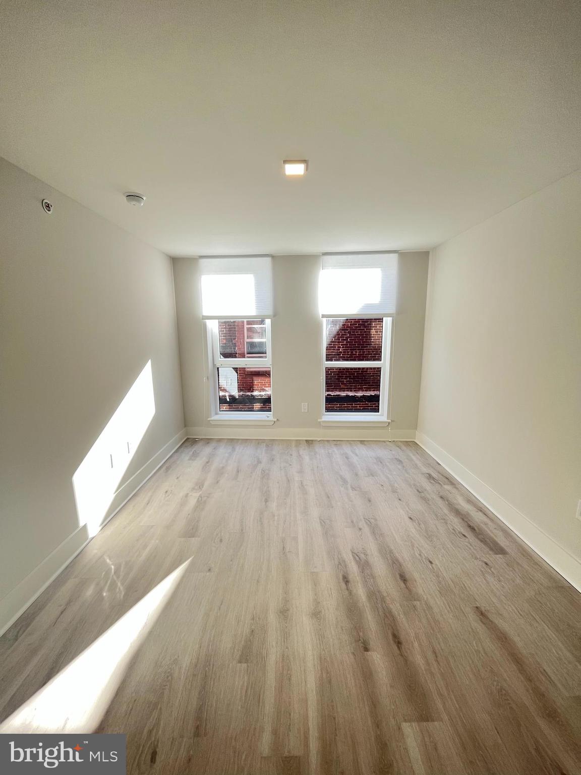 1805 North Howard Street, Unit 303 Philadelphia, PA 19122 - Photo 19 of 25 a view of a room with wooden floor and window