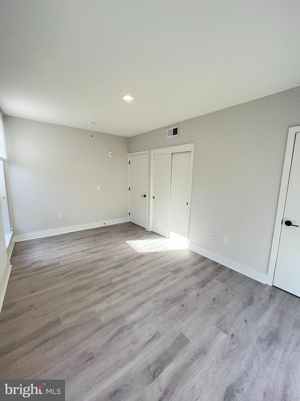 1805 North Howard Street, Unit 303 Philadelphia, PA 19122 - Photo 22 of 25 a view of an empty room with wooden floor