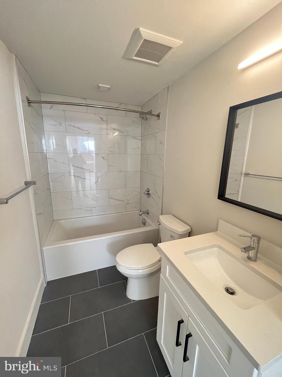 1805 North Howard Street, Unit 303 Philadelphia, PA 19122 - Photo 25 of 25 a bathroom with a sink a toilet a mirror and shower