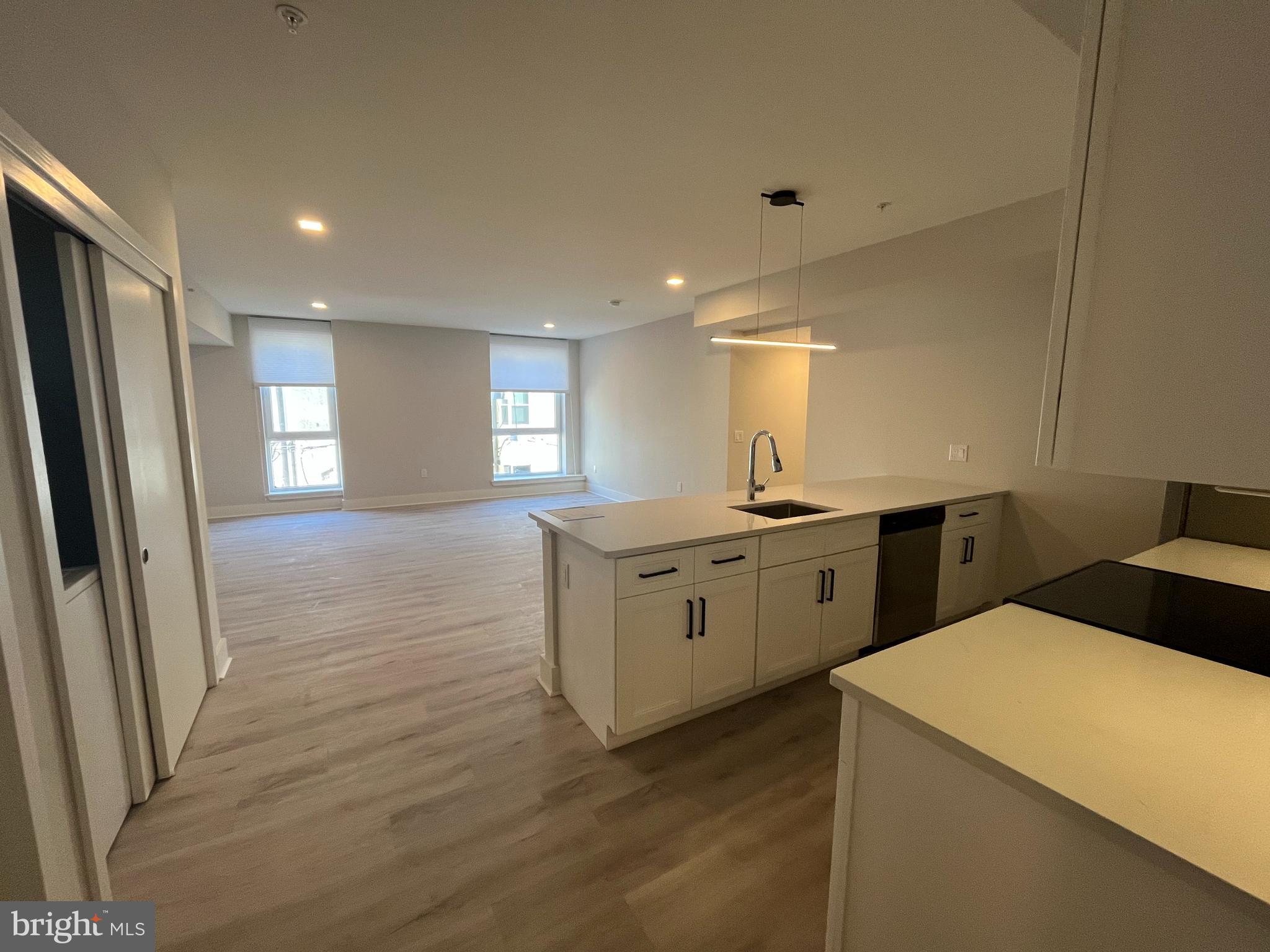 1805 North Howard Street, Unit 303 Philadelphia, PA 19122 - Photo 6 of 25 a kitchen with a refrigerator sink and cabinets