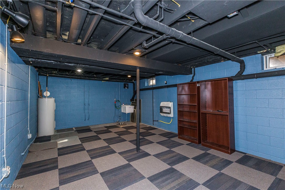 4069 Erhart Road Medina, OH 44256 - Photo 23 of 30 Basement with sink, electric water heater, and dark carpet