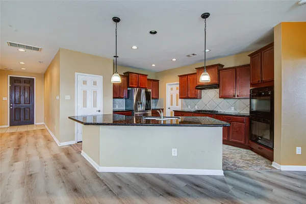 a large kitchen with stainless steel appliances kitchen island a large island in the center