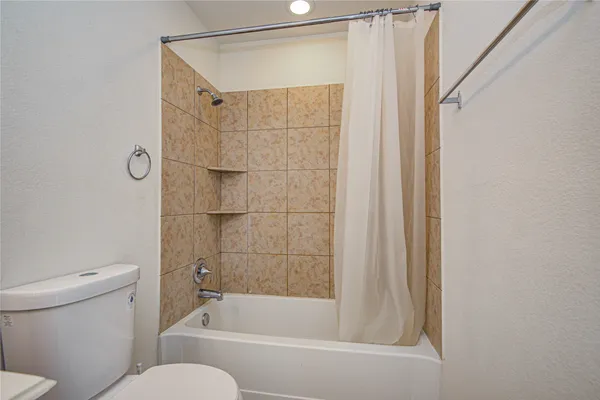 a bathroom with a shower and a toilet
