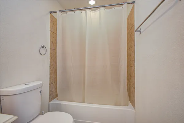 a bathroom with a shower and a toilet