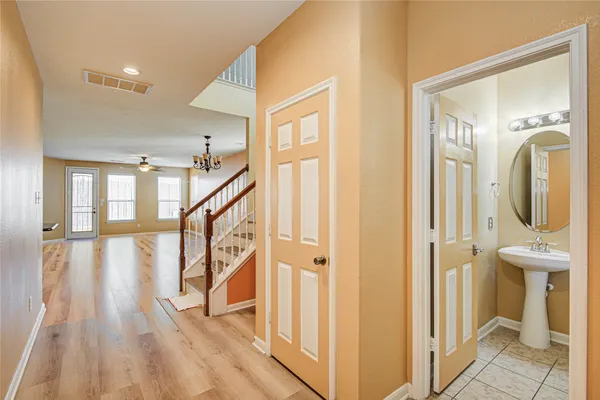 a view of an entryway with wooden floor and a livingroom