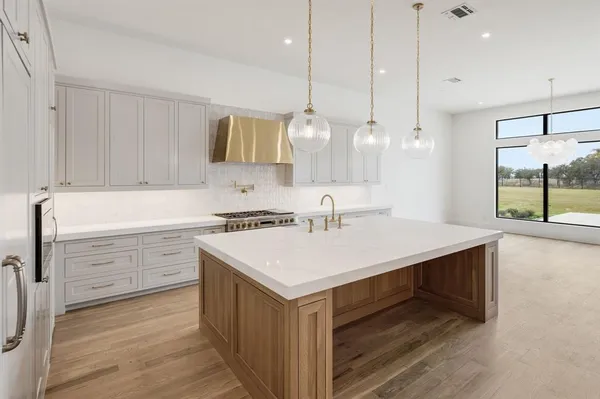 a kitchen with a sink a stove and a window