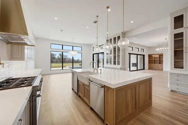 a open kitchen with stainless steel appliances granite countertop a stove and a sink