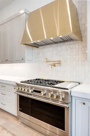 a stove top oven sitting inside of a kitchen