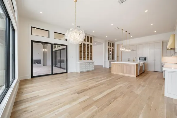 a view of a big room with kitchen and chandelier
