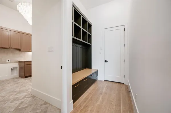 a view of hallway with stairs and wooden floor