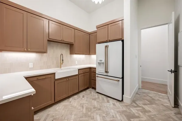 a kitchen with stainless steel appliances granite countertop a refrigerator and a sink