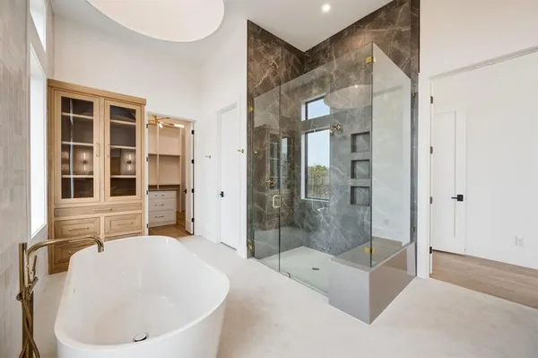 a bathroom with a bathtub and a shower