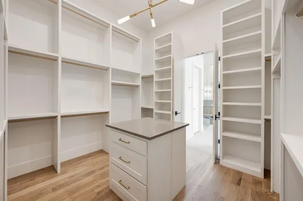 a kitchen with cabinets and wooden floor