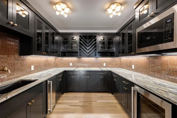 a kitchen with stainless steel appliances granite countertop a sink stove and cabinets