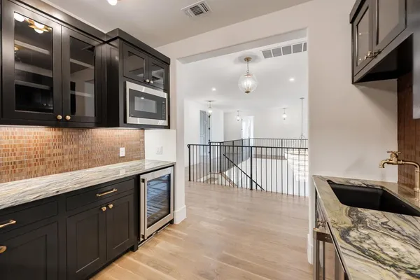 a kitchen with stainless steel appliances kitchen island granite countertop a sink and cabinets
