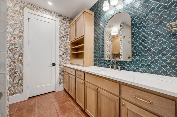 a bathroom with a sink and a mirror