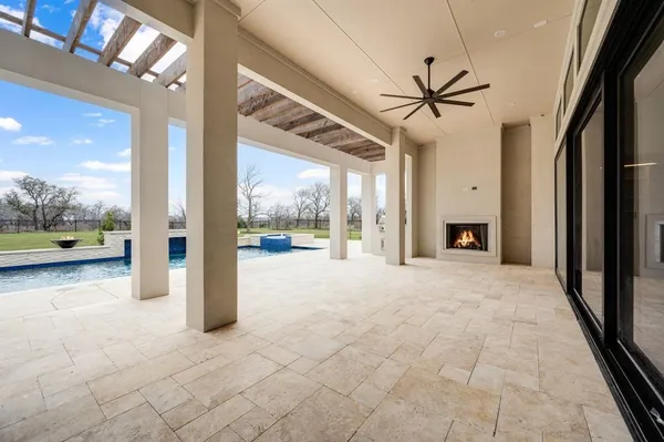 a view of an empty room with a fireplace and a window