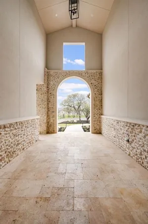 an empty room with windows and fireplace