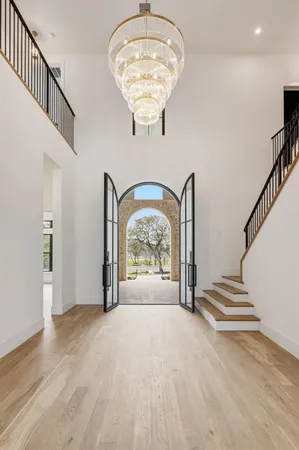 a view of entryway and hall with wooden floor