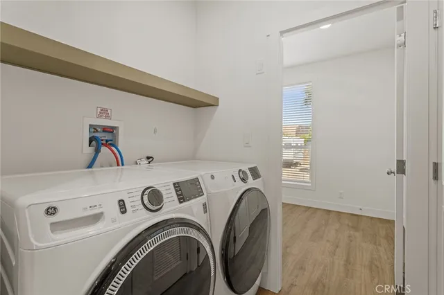 a view of washer and dryer with kitchen in the background