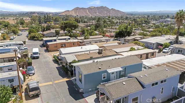 an aerial view of residential houses with outdoor space and street view