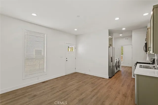 a large kitchen with a sink and a stove top oven