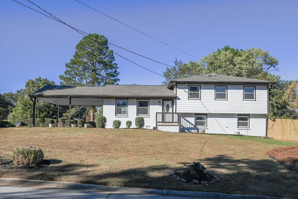 5186 Flemish Court Atlanta, GA 30349 - Photo 1 of 1 a front view of a house with a yard
