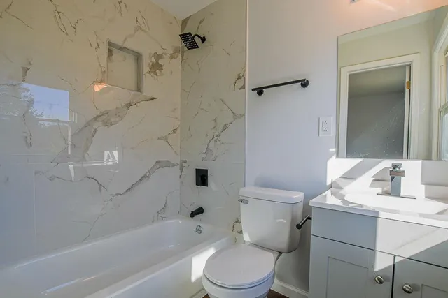 a bathroom with a sink toilet and shower