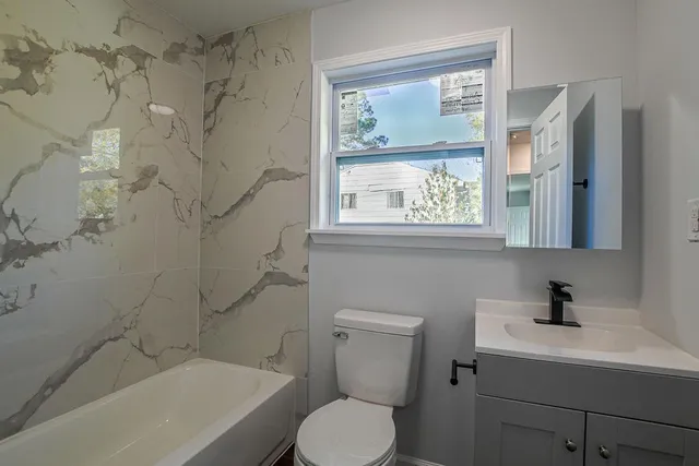 a white toilet sitting next to a bathroom sink