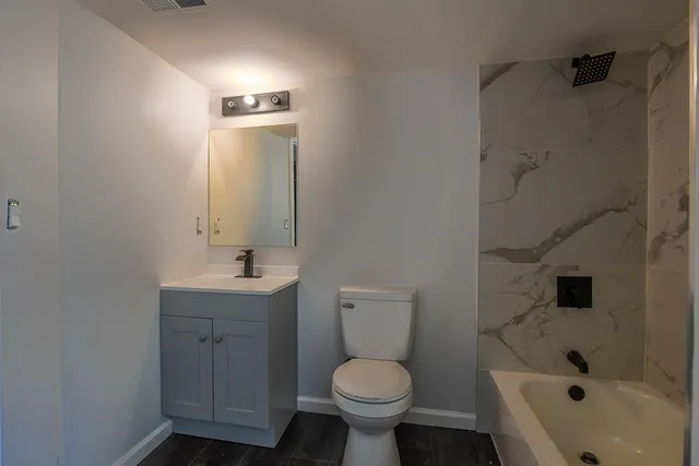 a bathroom with a sink toilet and shower